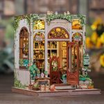 miniature bookshop with plant details and arched wooden facade