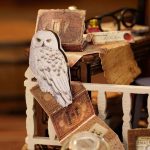 assembly-miniature-house-project-with-decorative-interiors Magic House miniature assembly step showing decorative interior details and furniture placement