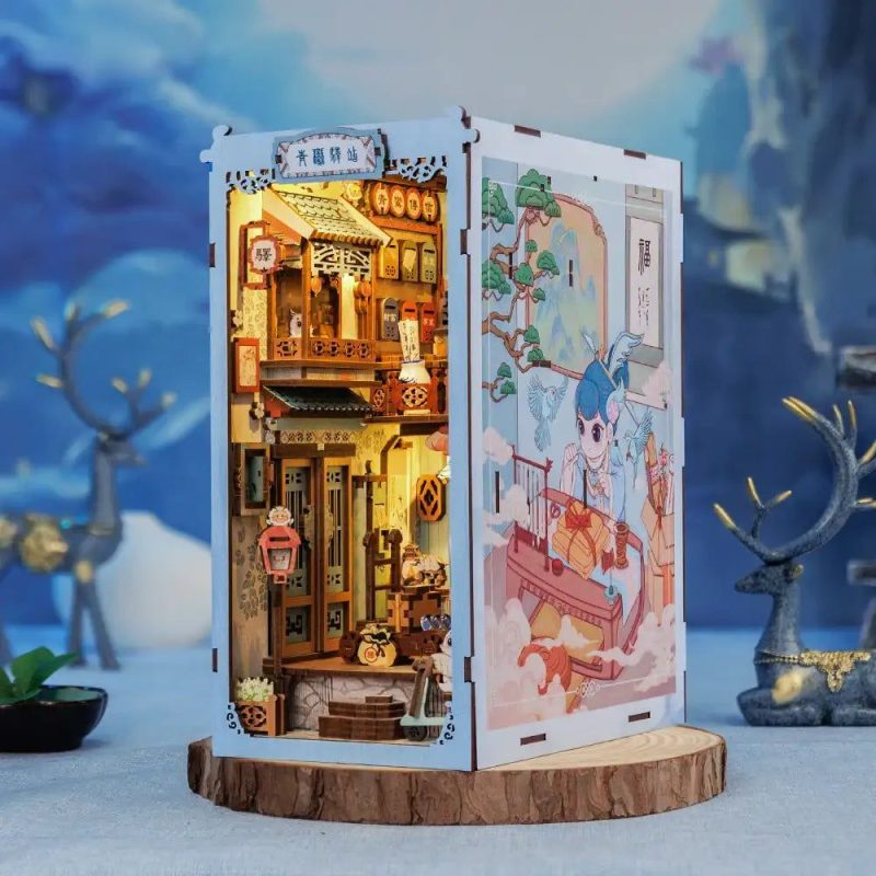 Azure Phoenix Lodge DIY book nook lit with warm amber LED on wooden shelf