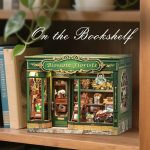 Blossom Florists floral diorama displayed between books on wooden shelf