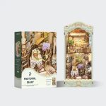 bookshelf-insert-featuring-village-cottage-diorama Bookshelf insert featuring village cottage diorama with warm amber lighting