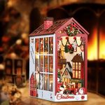 christmas-themed-miniature-bookshelf-scene Christmas-themed miniature bookshelf scene showing cottage windows, wreath details, and mailbox