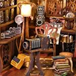 cinema-inspired-book-nook-diorama-with-vintage-camera Cinema-inspired book nook diorama with vintage camera and curled film prints