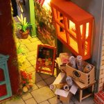 Cobblestone street book nook display featuring red telephone box accent piece
