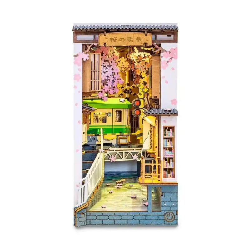 collectible-miniature-train-alley-book-nook-scene Collectible miniature train alley book nook scene with lanterns and blossoms