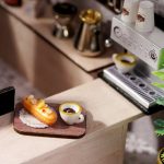compact-dollhouse-cafe-set-with-miniature-pastries-and-cups Compact dollhouse café set displaying miniature pastries and beverage cups
