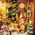 Cozy miniature Christmas street scene with warm glow as bookshelf insert decoration
