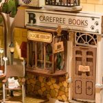 cozy-town-inspired-shelf-insert-with-tiny-books Cozy town-inspired book nook shelf insert with tiny painted books and cobblestone street
