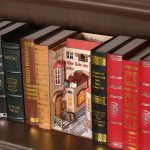 detailed-floral-city-bookend-scene-for-bookshelf Detailed floral city bookend scene placed between books on wooden shelf