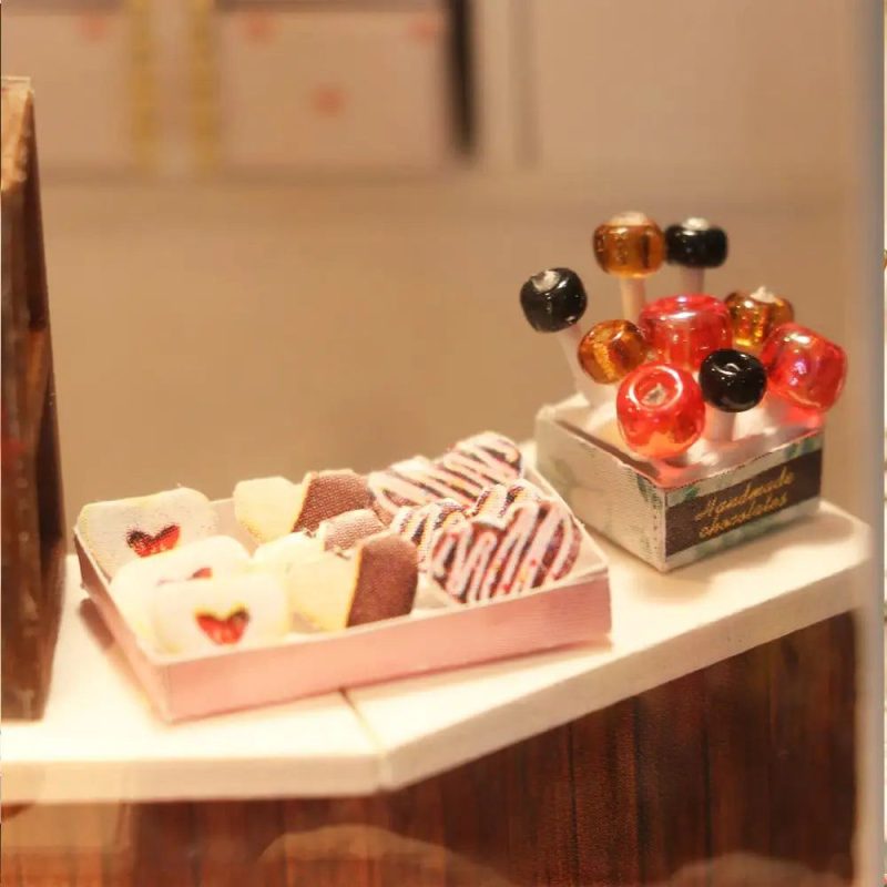 detailed-miniature-cocoa-themed-dollhouse-scene Detailed miniature cocoa-themed dollhouse scene with warm LED glow