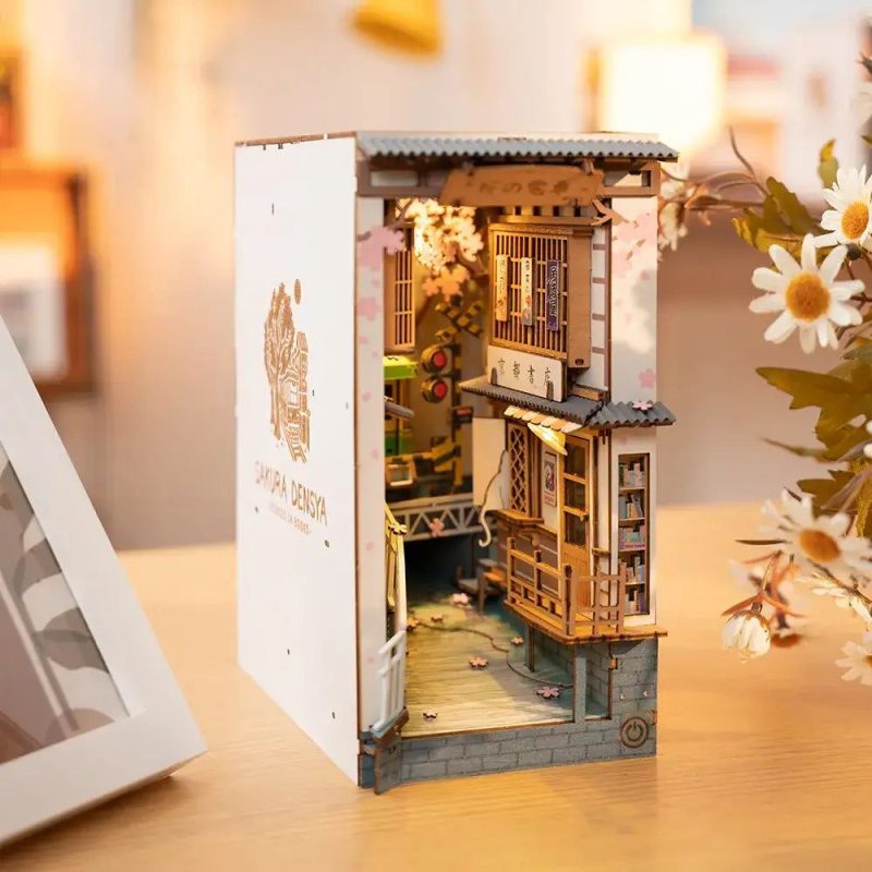 detailed-miniature-street-scene-book-nook-with-lanterns Detailed miniature street scene book nook with lanterns and cherry blossom canopy