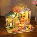 DIY miniature floral house model showing layered flower architecture and window details