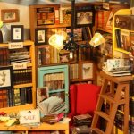 diy-miniature-house-interior-featuring-tiny-handcrafted-library DIY miniature house interior with handcrafted library shelves desk and lamp