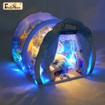 diy-miniature-ocean-house-craft-kit-with-nautical-decor DIY ocean miniature house craft kit showing handcrafted wood panels, shell accessories, and integrated warm LED light module