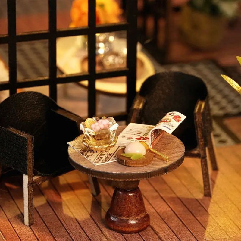diy-miniature-teashop-kit-with-wooden-furniture DIY miniature teashop kit showing pre-cut wooden furniture pieces and assembly tools