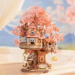 DIY wooden sakura tree cottage model mid-assembly close-up