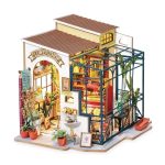 emily-s-handcrafted-miniature-flower-shop-model Emily's handcrafted miniature flower shop model with fabric awning and warm amber glow