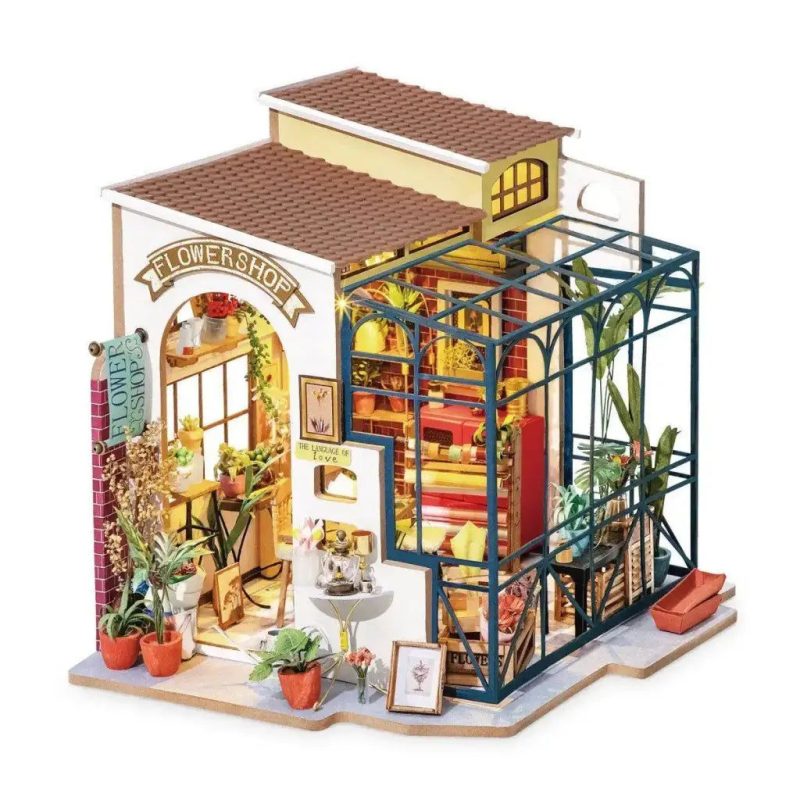 emily-s-handcrafted-miniature-flower-shop-model Emily's handcrafted miniature flower shop model with fabric awning and warm amber glow