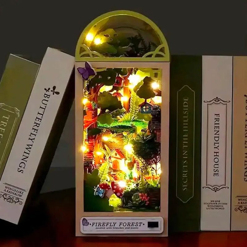 enchanted-forest-bookshelf-diorama-with-glowing-fireflies Enchanted forest diorama with layered foliage and glowing warm firefly LED lights in book nook