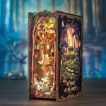 forest-themed-book-nook-diorama-for-shelves Forest-themed book nook diorama with layered paper trees and warm amber lighting for shelves