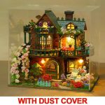 Hand-painted fairy cottage model kit showing painted trim and wood grain texture
