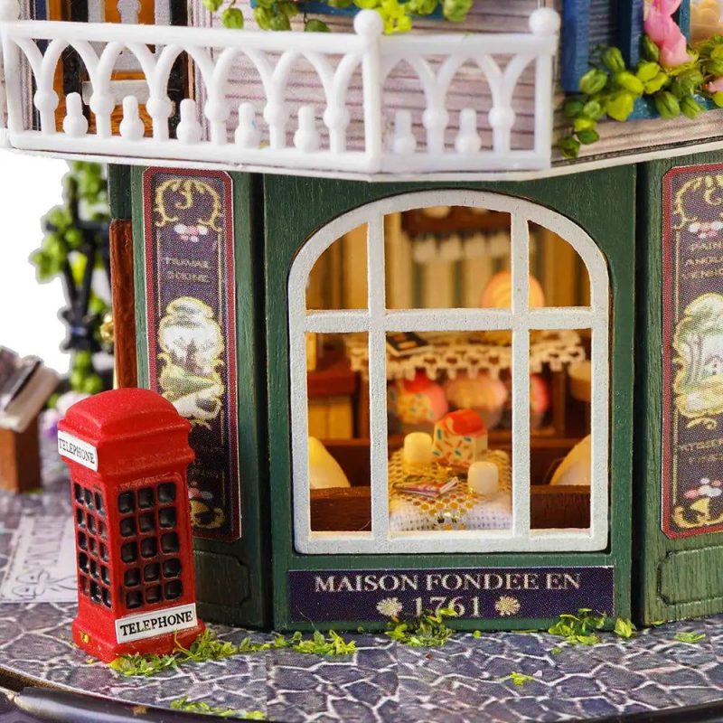 hand-painted-tiny-model-house-craft-for-hobbyists-and-collectors Hand-assembled tiny model house craft showing basswood edges and delicate door trim detail