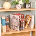 handcrafted-book-nook-depicting-a-blooming-ancient-town Handcrafted book nook with blooming ancient town balconies and stone facades