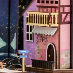 handcrafted-fairytale-village-bookshelf-insert-with-led-lights Handcrafted fairytale village bookshelf insert with warm LED lights illuminating timber frame houses