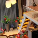 handcrafted-miniature-apartment-scene-with-detailed-decor-elements Handcrafted miniature apartment scene showing detailed decor and textile accents