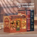 handcrafted-miniature-bakery-book-nook-for-bookshelf-display Handcrafted miniature bakery book nook insert displayed between novels on shelf
