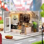 handcrafted-miniature-cafe-interior-for-collectible-dollhouse Handcrafted miniature cafe interior showing table settings and décor