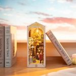 handcrafted-reading-corner-miniature-with-warm-led-lights Handcrafted reading corner miniature with warm amber LED lights casting shadows on balconies