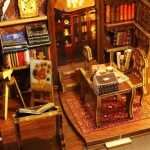 handcrafted-shelf-insert-literary-scene-with-stacked-books Handcrafted shelf insert showing literary scene with stacked miniature books and staircase