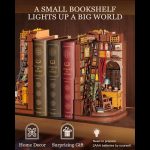 handcrafted-wooden-bookshelf-insert-diorama-with-reading-desk-and-lamp Handcrafted wooden book nook diorama showing detailed reading desk, shelves, and miniature lamp