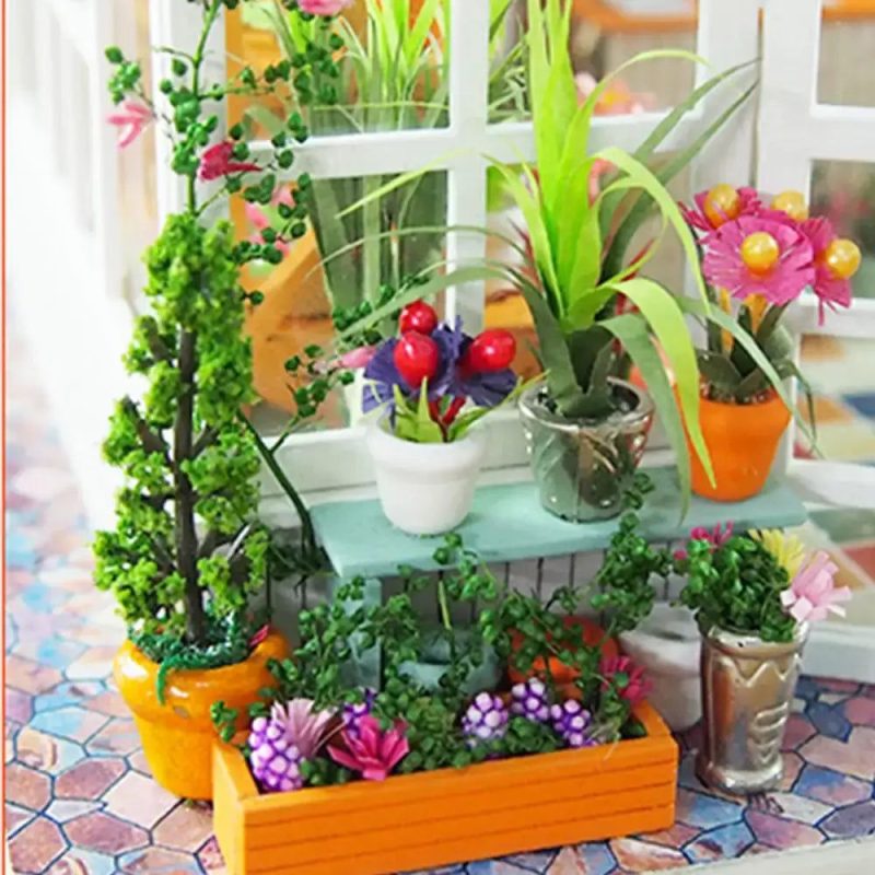 handmade-miniature-house-with-floral-decorations Handmade miniature house with floral decorations on wooden shelf