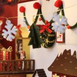 holiday-bookshelf-insert-with-snowy-village Holiday bookshelf insert with snowy village scene and mechanical music box mechanism visible