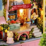 led-illuminated-miniature-theater-display-with-tiny-props LED-illuminated miniature theater display with warm lighting and tiny props on wooden base