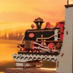 led-illuminated-train-book-nook-diorama-for-readers LED illuminated train book nook diorama glowing on reader shelf at night