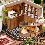 miniature-forest-tea-room-with-detailed-accessories Miniature forest tea room decorated with detailed ceramic ferns, menu board, and tiny furniture