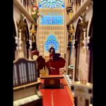 miniature-notre-dame-scene-paper-craft-kit-for-bookshelves paper and wood diorama of cozy bookstore interior with warm glow