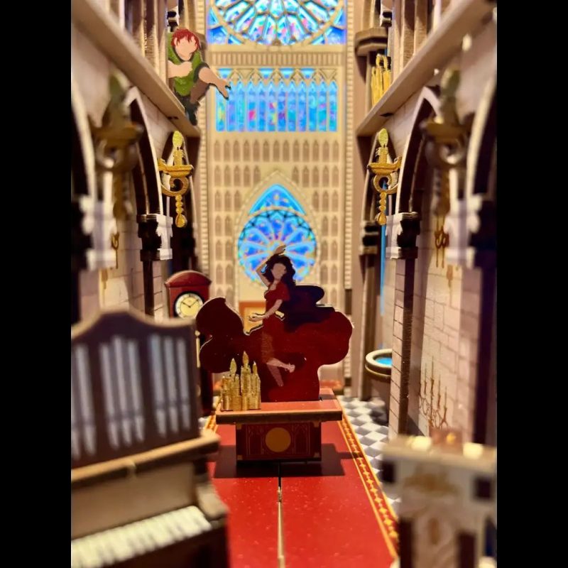 miniature-notre-dame-scene-paper-craft-kit-for-bookshelves paper and wood diorama of cozy bookstore interior with warm glow
