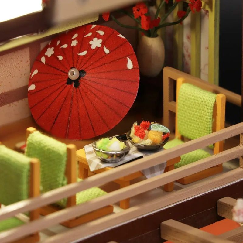 miniature-sushi-accessories-for-dollhouse-display Miniature sushi bar accessories including condiment bottles and chopstick rests for dollhouse