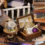 miniature-wooden-dollhouse-crafting-kit-for-hobbyists Miniature wooden dollhouse crafting kit displaying pre-cut basswood panels and components