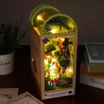 miniature-woodland-book-nook-with-warm-led-lights DIY miniature woodland book nook with warm LED string threading through forest canopy layers