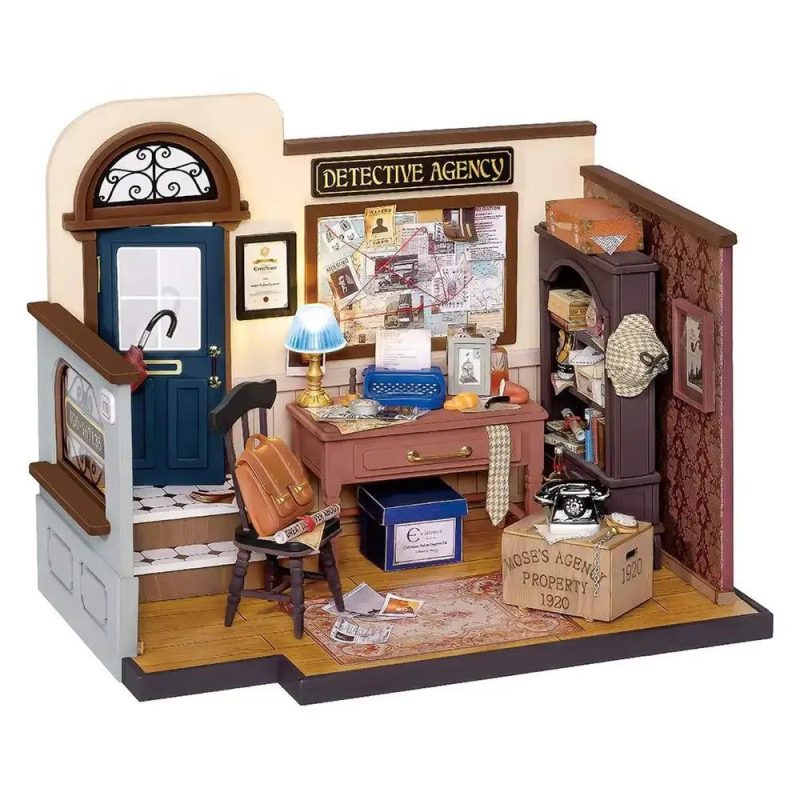 mose-s-detective-agency-diy-miniature-house-kit Mose's Detective Agency miniature house fully assembled on bookshelf with warm desk lamp casting shadows