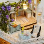 night-sky-themed-miniature-home-assembly-kit-for-tabletop-display Night-sky themed miniature home assembly kit displayed on tabletop shelf with accent lighting