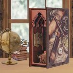 ocean-themed-book-nook-with-tiny-ship-model Ocean themed book nook with tiny ship model, lighthouse, and fabric ocean backdrop