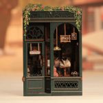 owl-perched-in-miniature-bookstore-diorama Owl figurine perched inside finished miniature bookstore diorama with LED glow