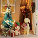 scaled-miniature-holiday-room-with-furniture-and-lights Scaled miniature holiday room with furniture and warm glowing LED lights creating cozy festive ambiance