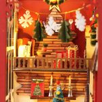 seasonal-book-nook-scene-with-cozy-cottage Seasonal book nook scene with cozy cottage, tiny Christmas tree, and miniature figures